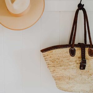 Hand bag and a cap hanging on the wall