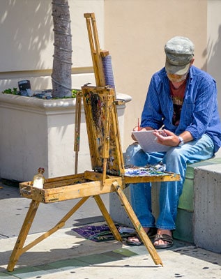 An artist paints a picture on easel