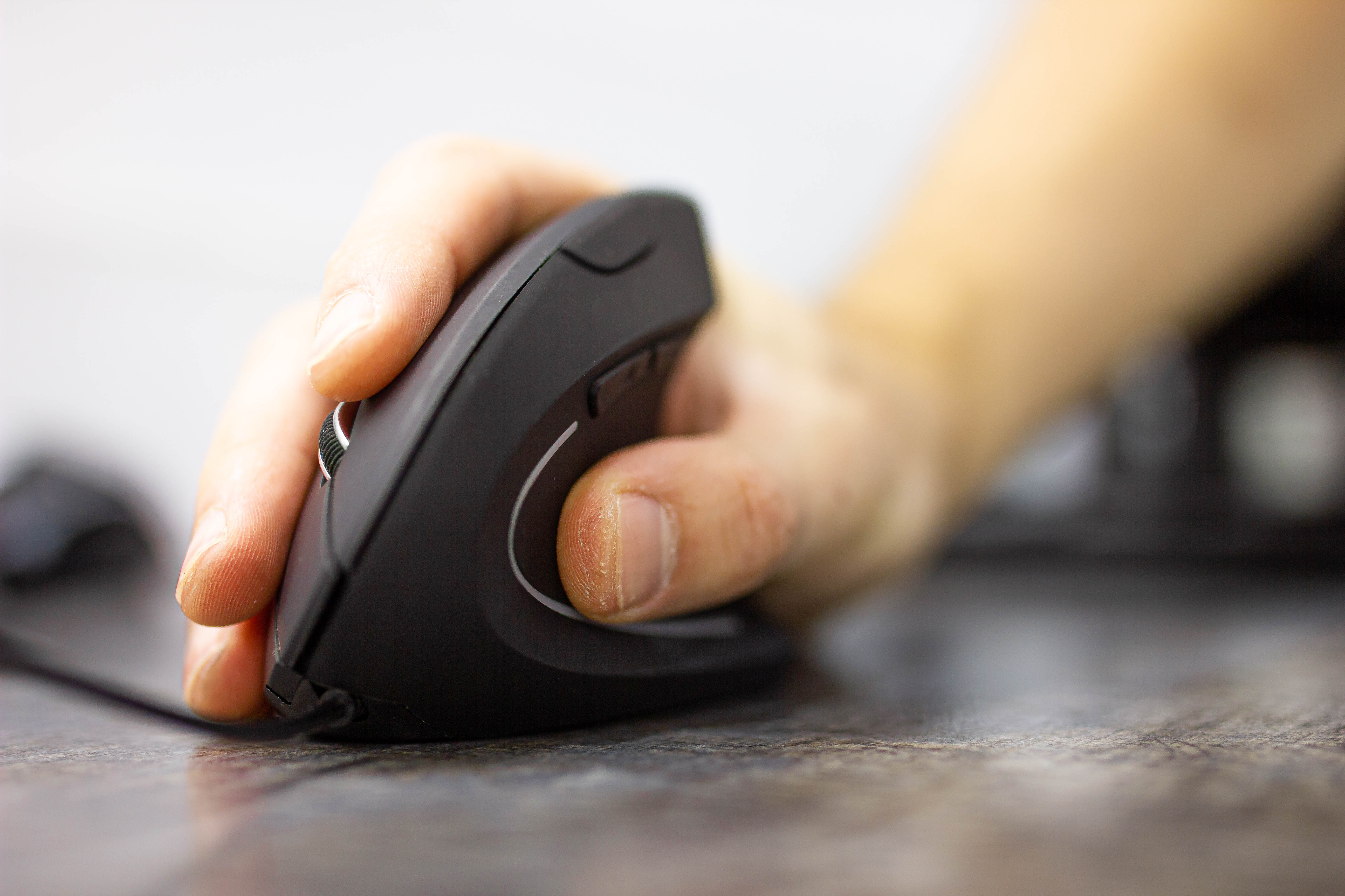 A Person handling right handed ergonomic mouse