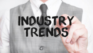 Businessman writing word INDUSTRY TRENDS with marker, Business concept