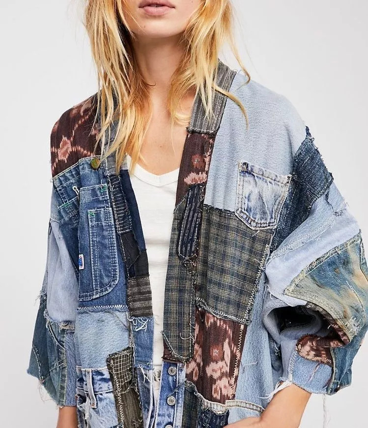 Stylish and one-of-a-kind denim jacket with kimono-inspired silhouette, open front, oversized style, raw trims, and hip pockets.